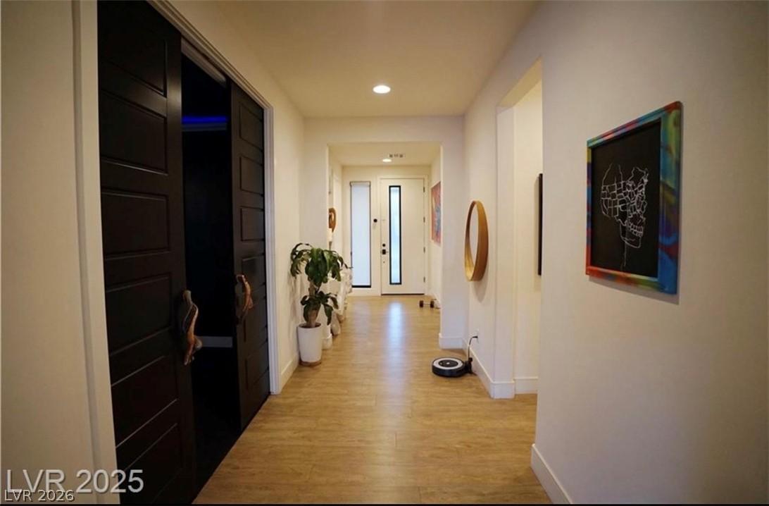 Image 3: A well-lit corridor with recessed lighting and woo