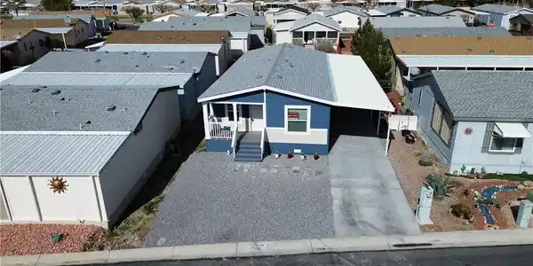 Image 2: A welcoming front facade with a covered carport of