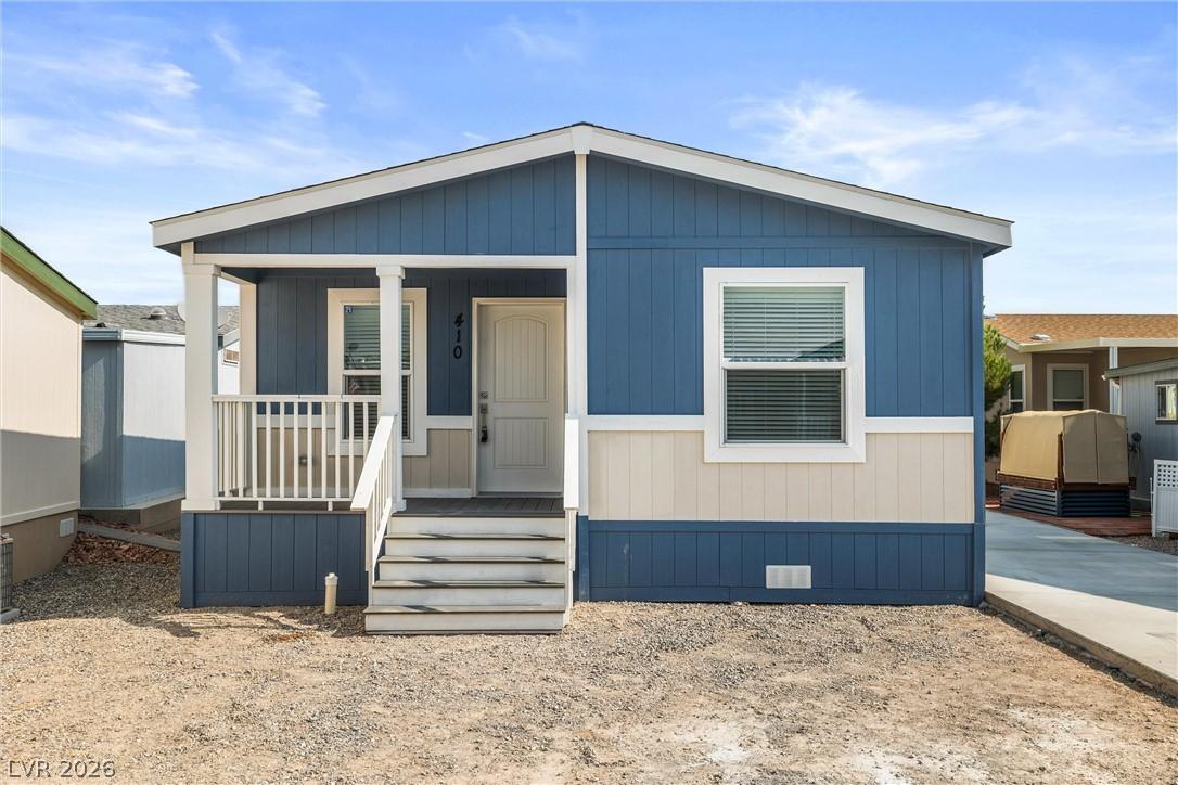 Image 4: A welcoming front porch leads to this charming blu