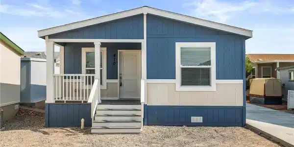 Image 4: A welcoming front porch leads to this charming blu