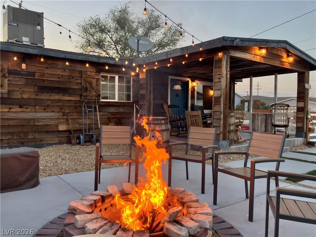 Image 1: A charming fire pit area offers cozy outdoor eveni