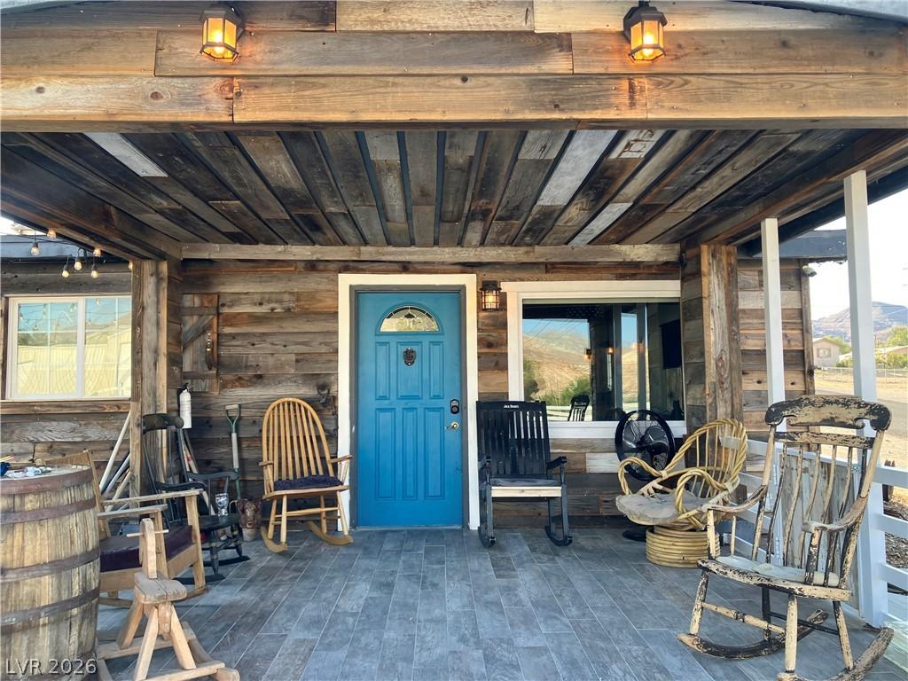 Image 2: A welcoming wooden porch with a bright blue entry