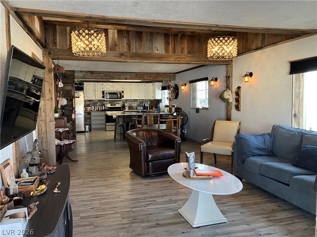 Image 3: Exposed wood beams and elegant fixtures create an