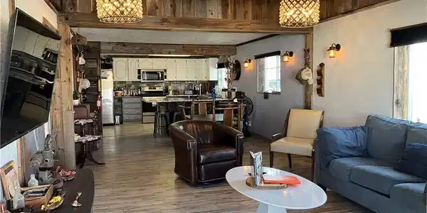 Image 3: Exposed wood beams and elegant fixtures create an