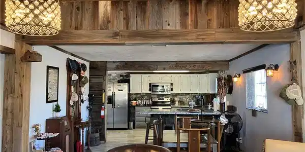 Image 4: Natural wood beams and paneling lend a rustic char