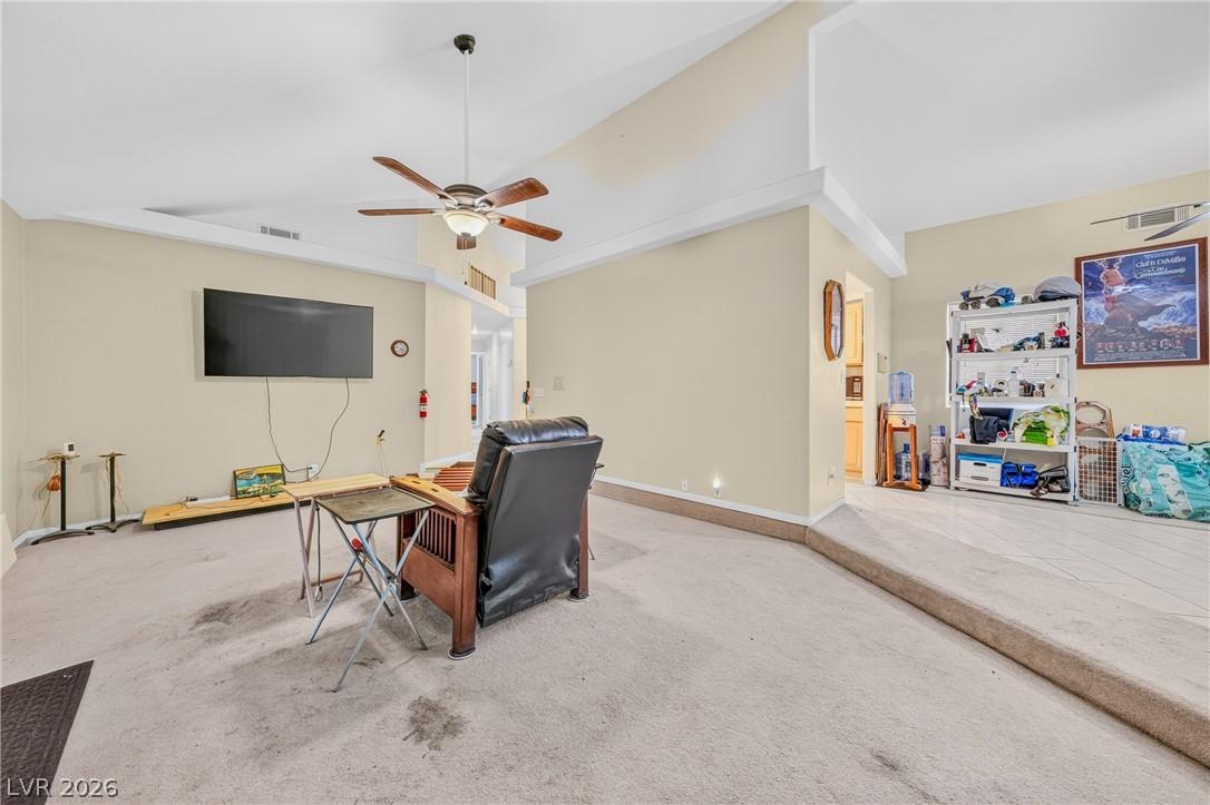 Image 4: A welcoming living room featuring vaulted ceilings