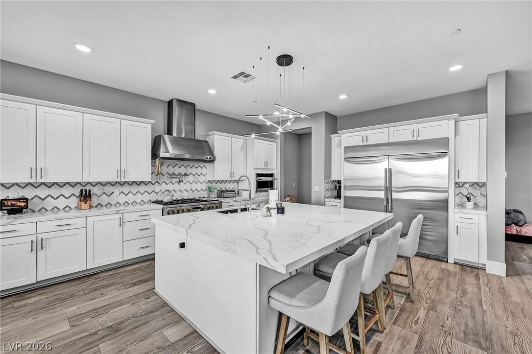 Image 3: A well-appointed kitchen features a spacious islan