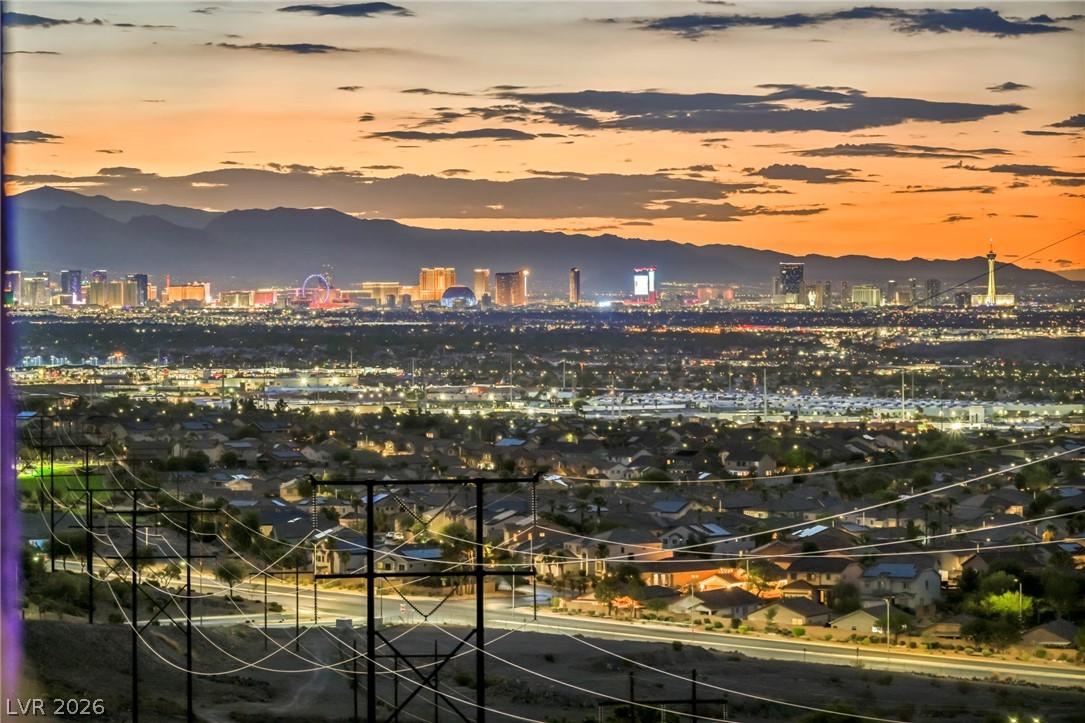 Image 4: A vibrant cityscape lights up the horizon against