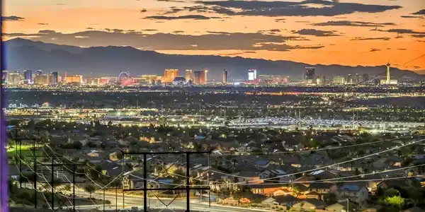 Image 4: A vibrant cityscape lights up the horizon against