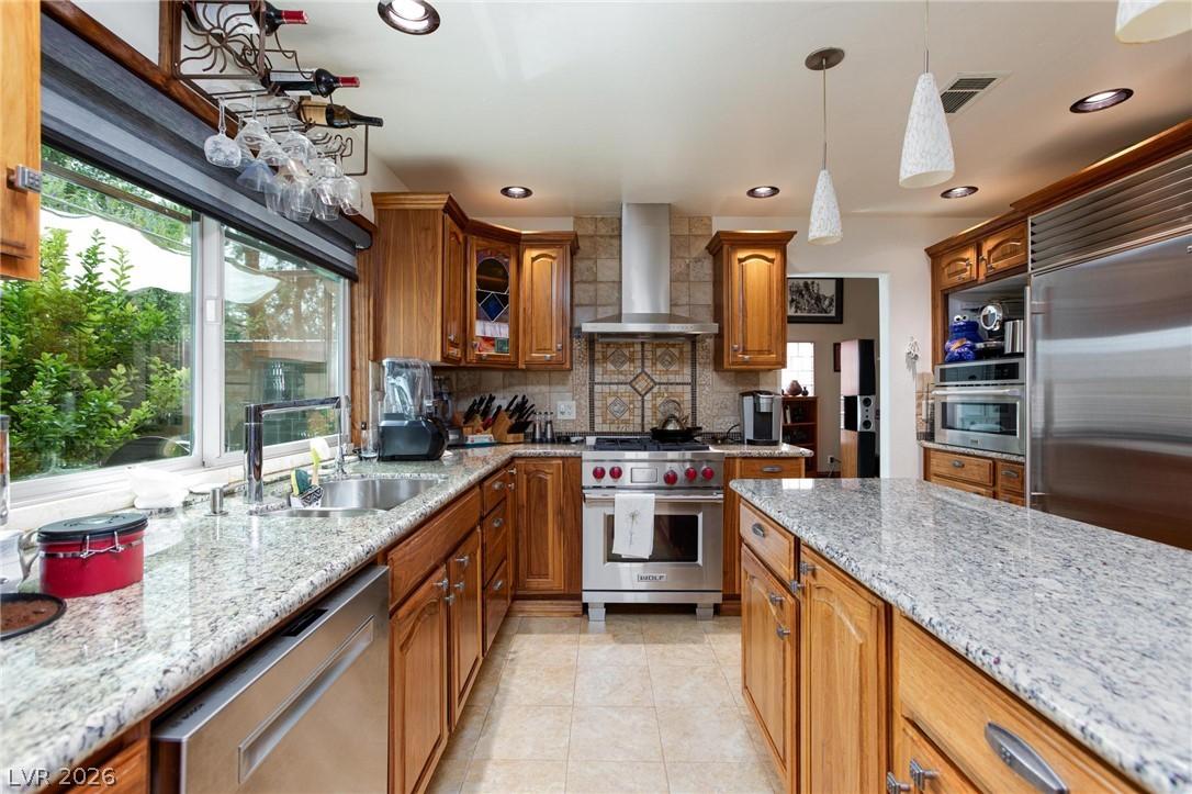 Image 2: A gourmet kitchen boasts granite counters, ample c
