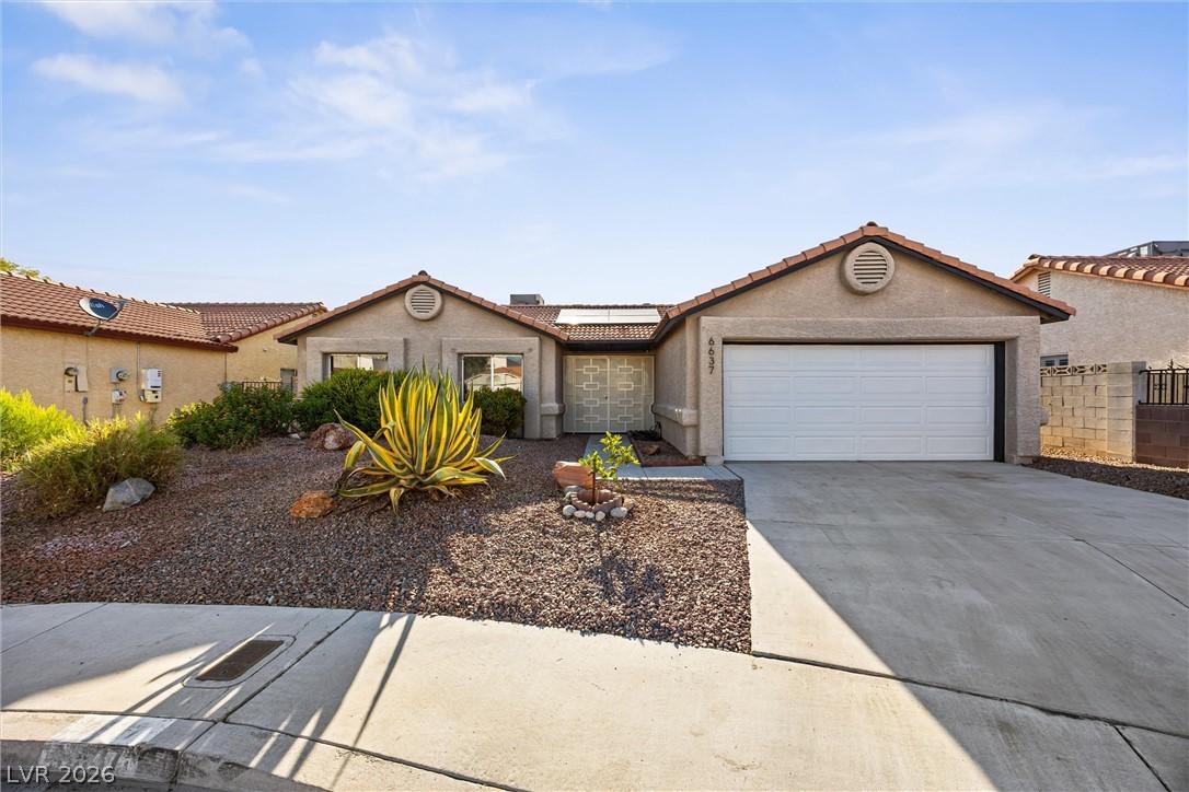 Image 1: A desert-friendly landscape accents this charming