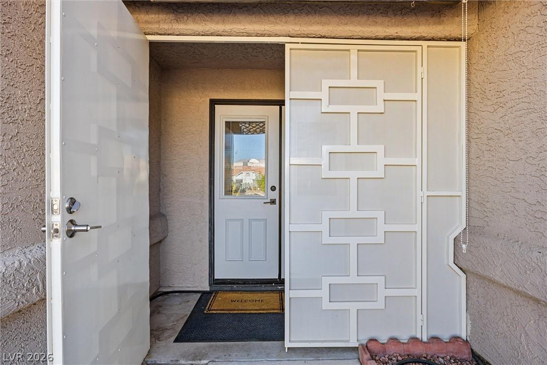Image 4: A welcoming entry features a stylish security scre
