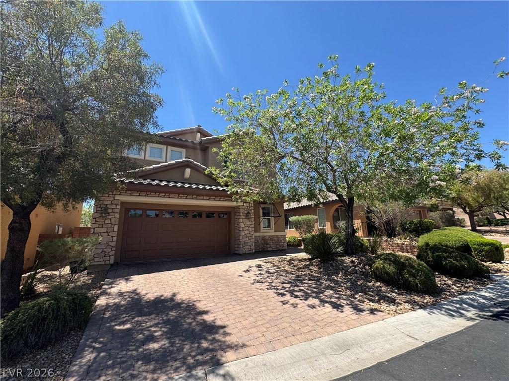 Image 2: An inviting paver driveway leads to front yard fea