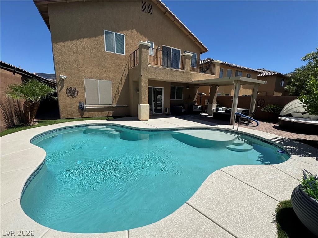Image 3: A backyard oasis awaits with a sparkling blue pool
