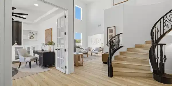 Image 4: Light hardwood floors and a curved staircase ancho