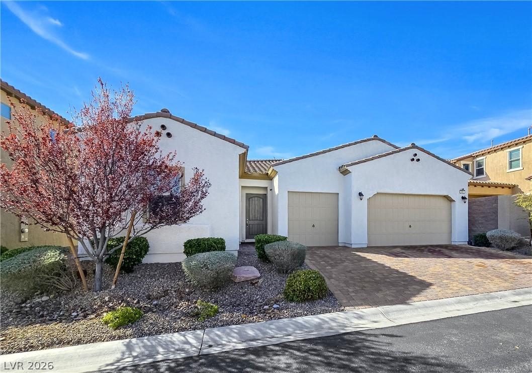Image 2: A well-maintained desert landscape and paver drive