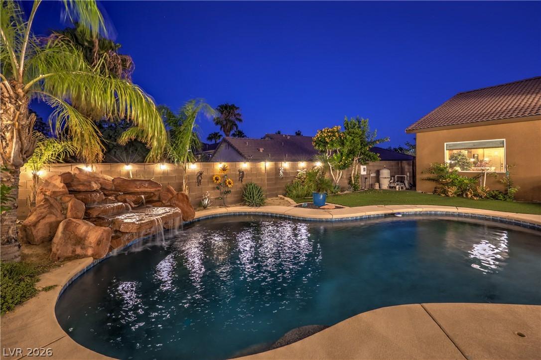 Image 2: A tranquil backyard oasis features a rock waterfal
