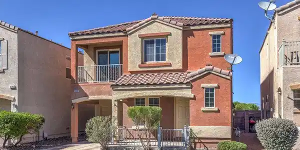 Image 2: Spanish tile roofing and warm stucco accents defin