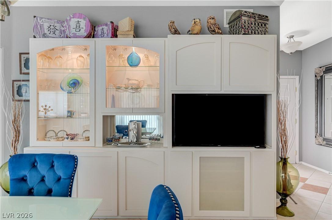 Image 4: Built-in cabinetry with glass display fronts defin