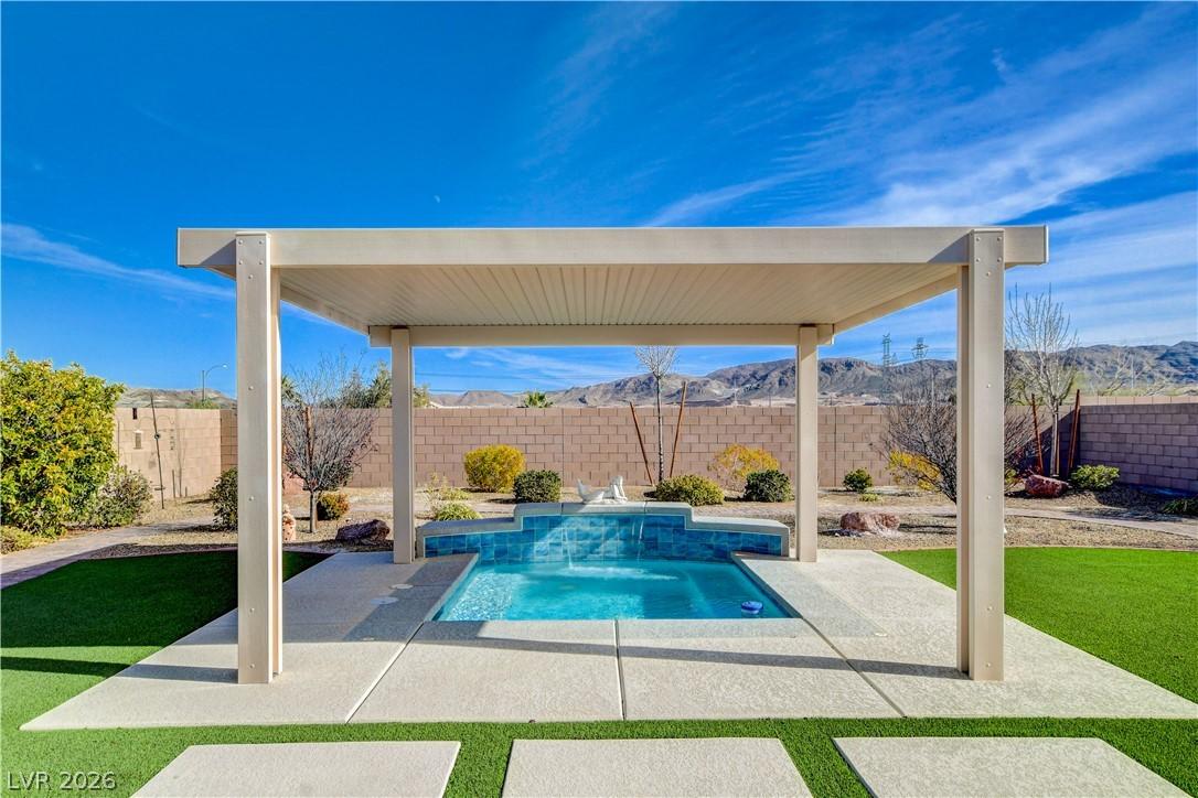 Image 2: A tranquil backyard spa beneath a modern pergola o