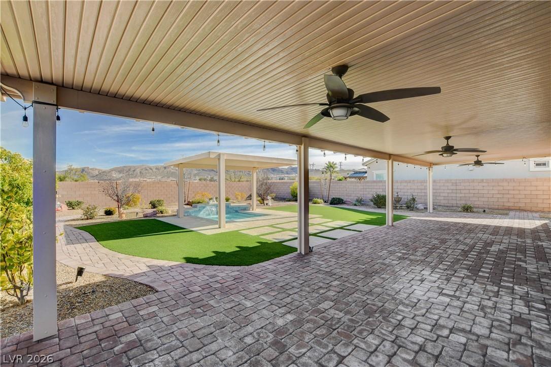 Image 3: An inviting covered patio offers ample space for e