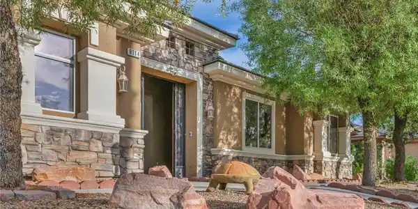 Image 3: Textured stone accents and desert landscaping crea