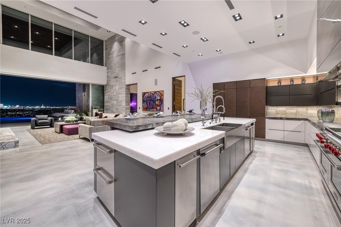 Image 3: Kitchen featuring a high ceiling, a sink, a large