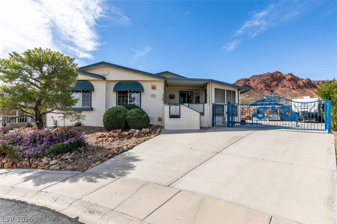 Image 4: Front of the home with automated gate & RV parking