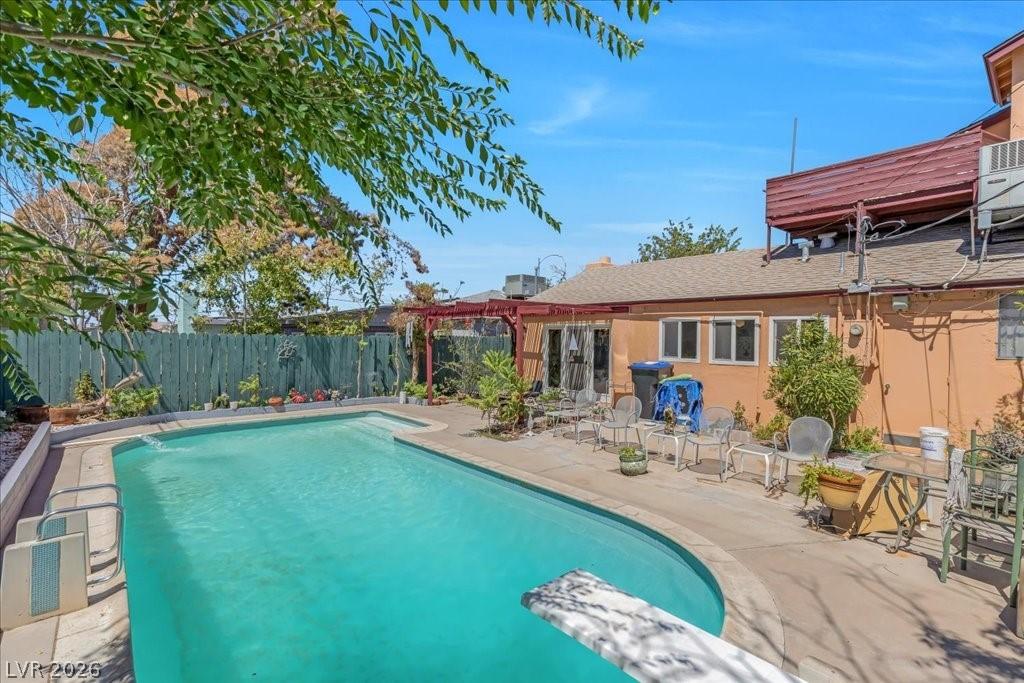 Image 1: An inviting backyard oasis awaits with a refreshin