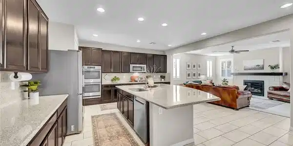 Image 4: A grand kitchen island with granite counters exten