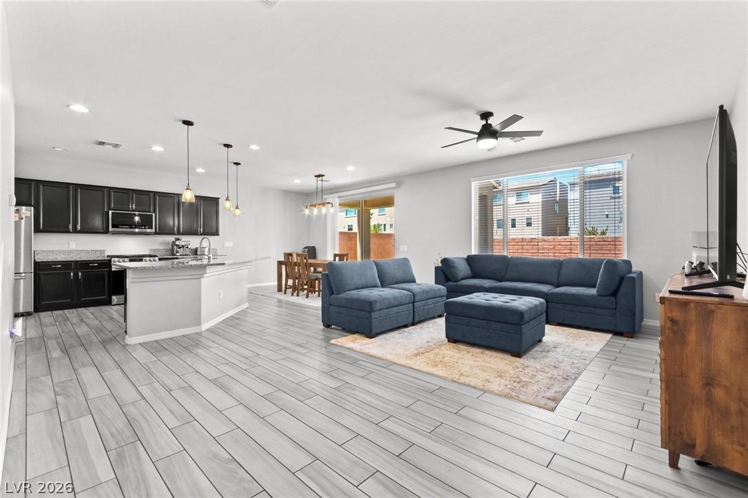 Image 2: An open-concept living space integrates a modern k