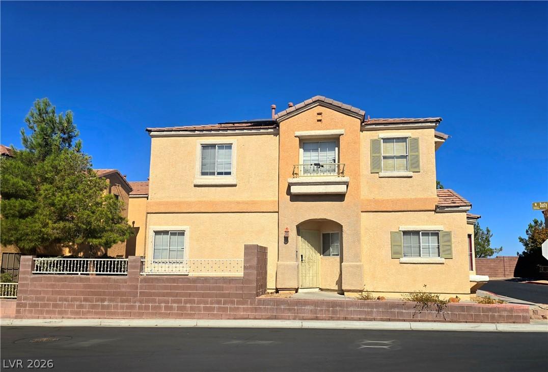 Image 2: A striking desert home with warm stucco and tile r