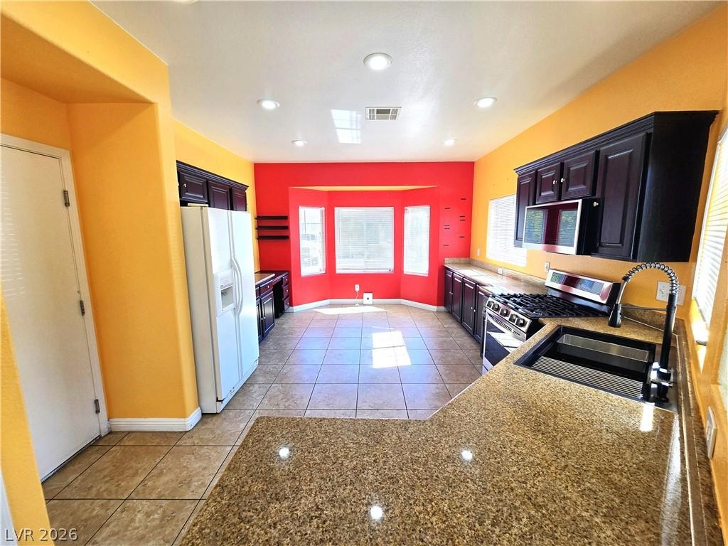 Image 4: A well-appointed kitchen features ample counter sp