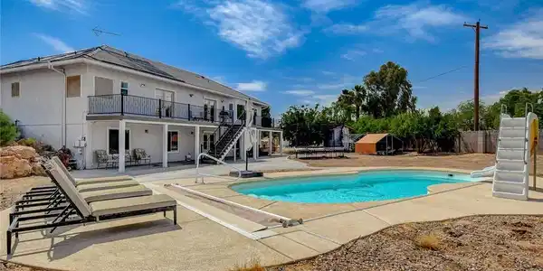 Image 2: An inviting backyard oasis awaits with a sparkling