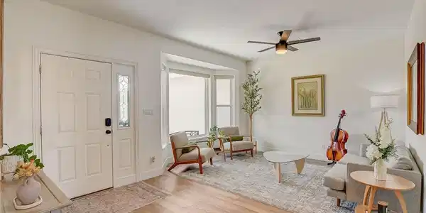 Image 4: LVP and bay windows enhance this airy and inviting