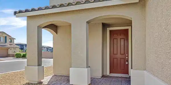 Image 2: Stucco arches frame the welcoming paved entryway u