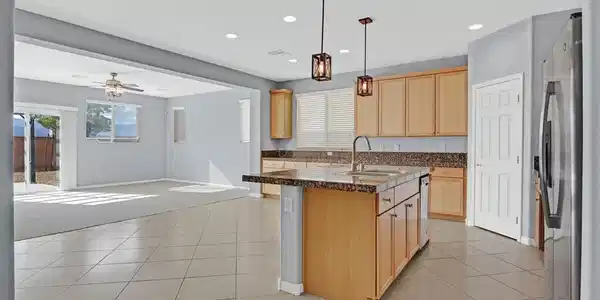 Image 4: Seamless tile flooring connects a spacious center-