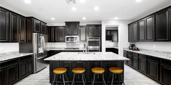 Image 3: Dark cabinetry beautifully contrasts with light gr
