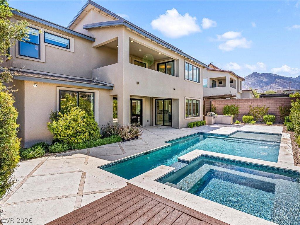 Image 2: An inviting backyard oasis offers a sparkling pool