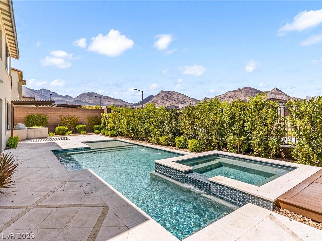 Image 3: An inviting pool and spa beckon with mountain vist