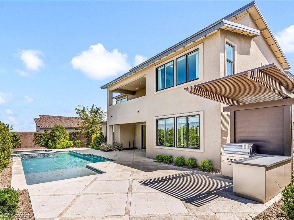 Image 4: An inviting backyard oasis offers a sparkling pool