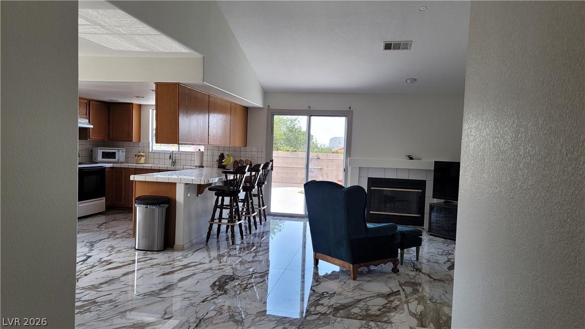 Image 1: Reflective tiled floors extend across an open-conc
