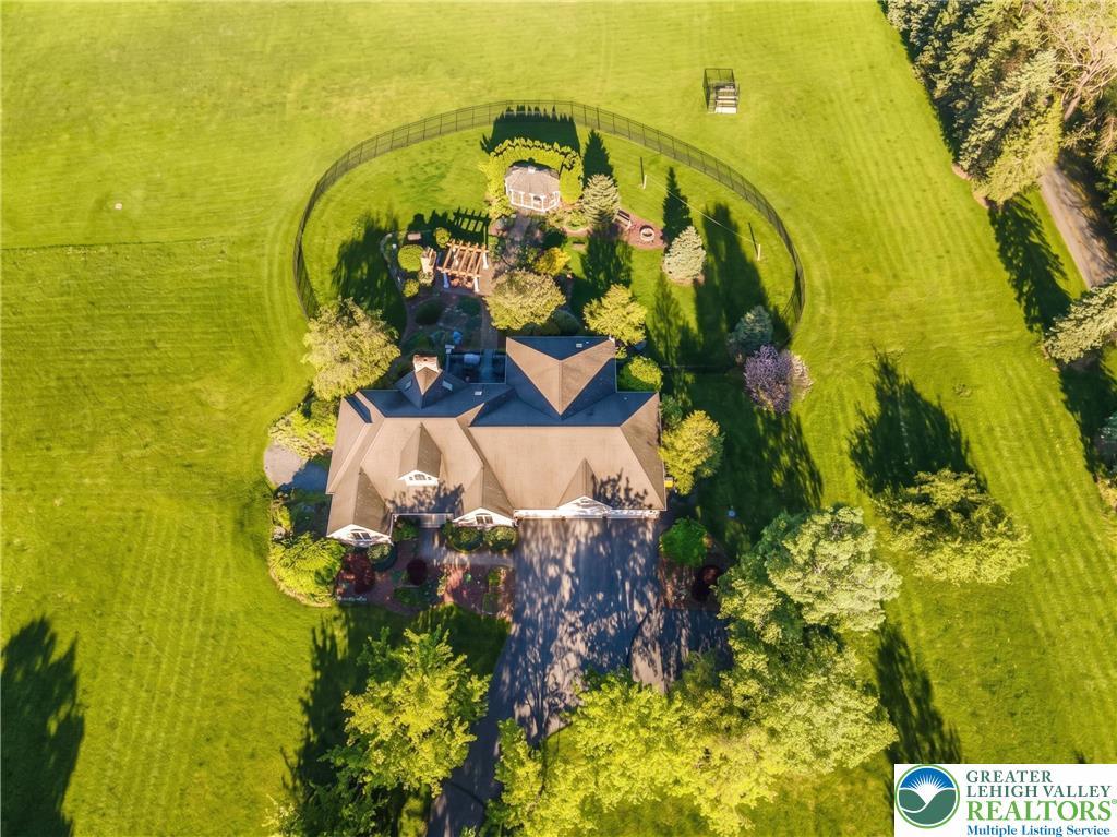 Image 2: An aerial view showcases a grand residence amidst