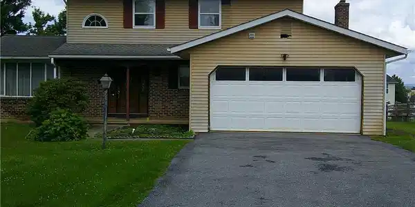 Image 2: A classic two-story residence with an attached gar