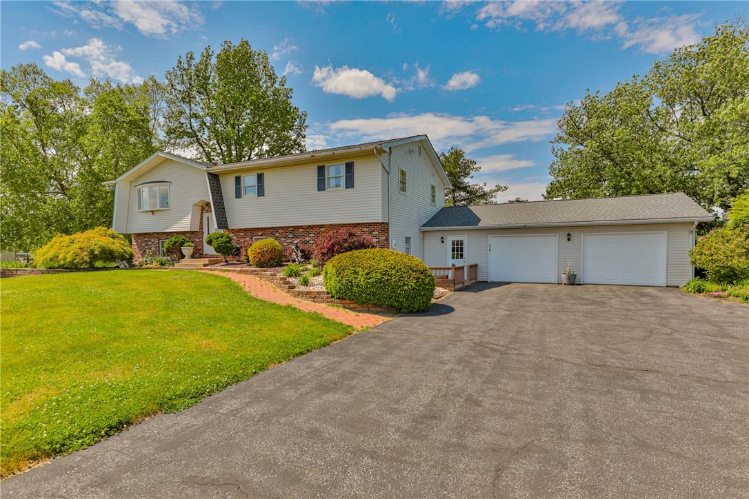 Image 2: A classic facade with a generous driveway and mani
