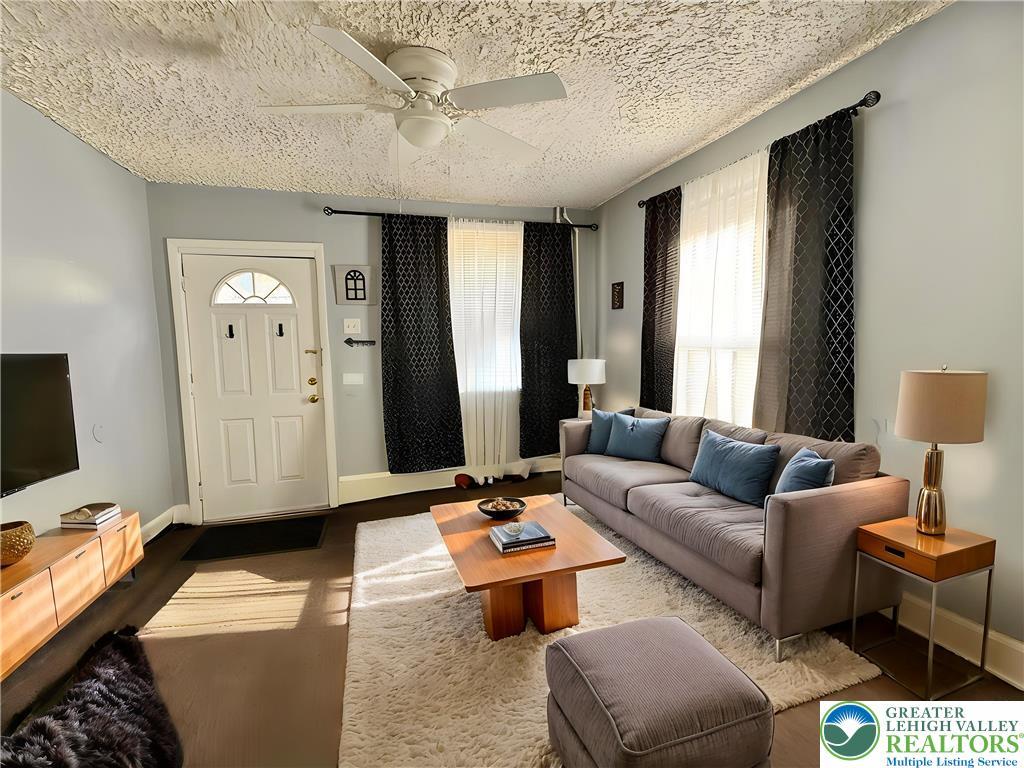 Image 2: A well-appointed living room offers ample natural