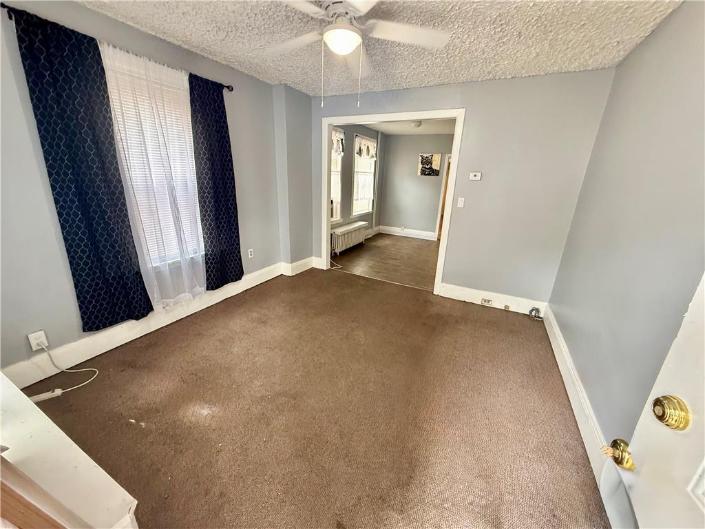 Image 3: A versatile living area with soft carpeting and na