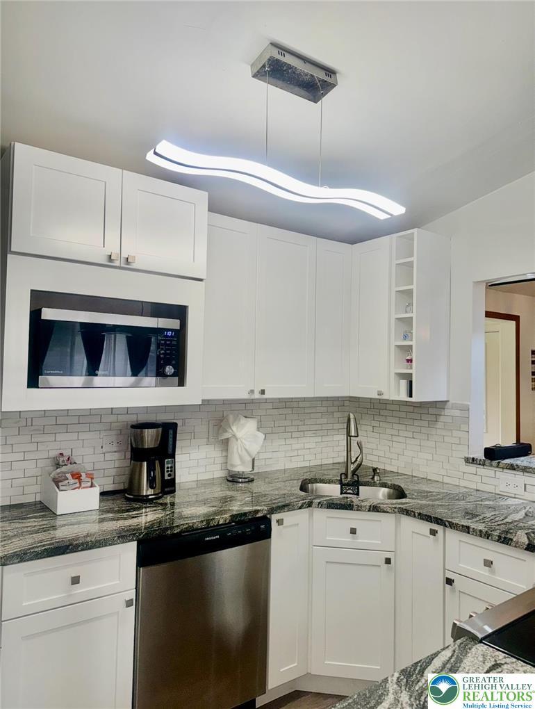 Image 3: Modern kitchen with sleek cabinetry and durable gr