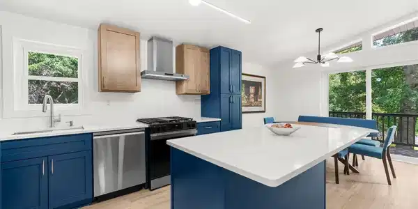 Image 3: A contemporary kitchen/dining room open to deck.