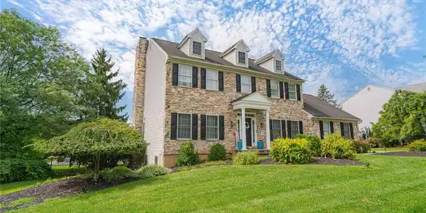 Image 2: A classic stone facade and dormer windows define t